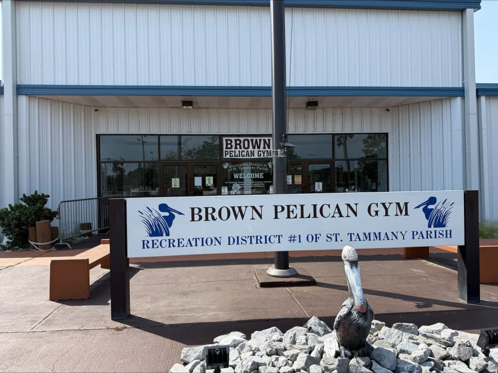 Front of Brown Pelican Gym storefront with glass doors and a large sign reading 'BROWN PELICAN GYM' above the entrance.